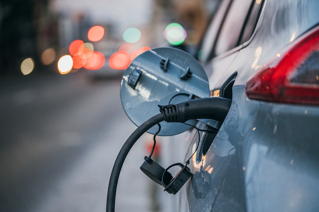 Close-up of an electric car charging — connector plugged into the charge port